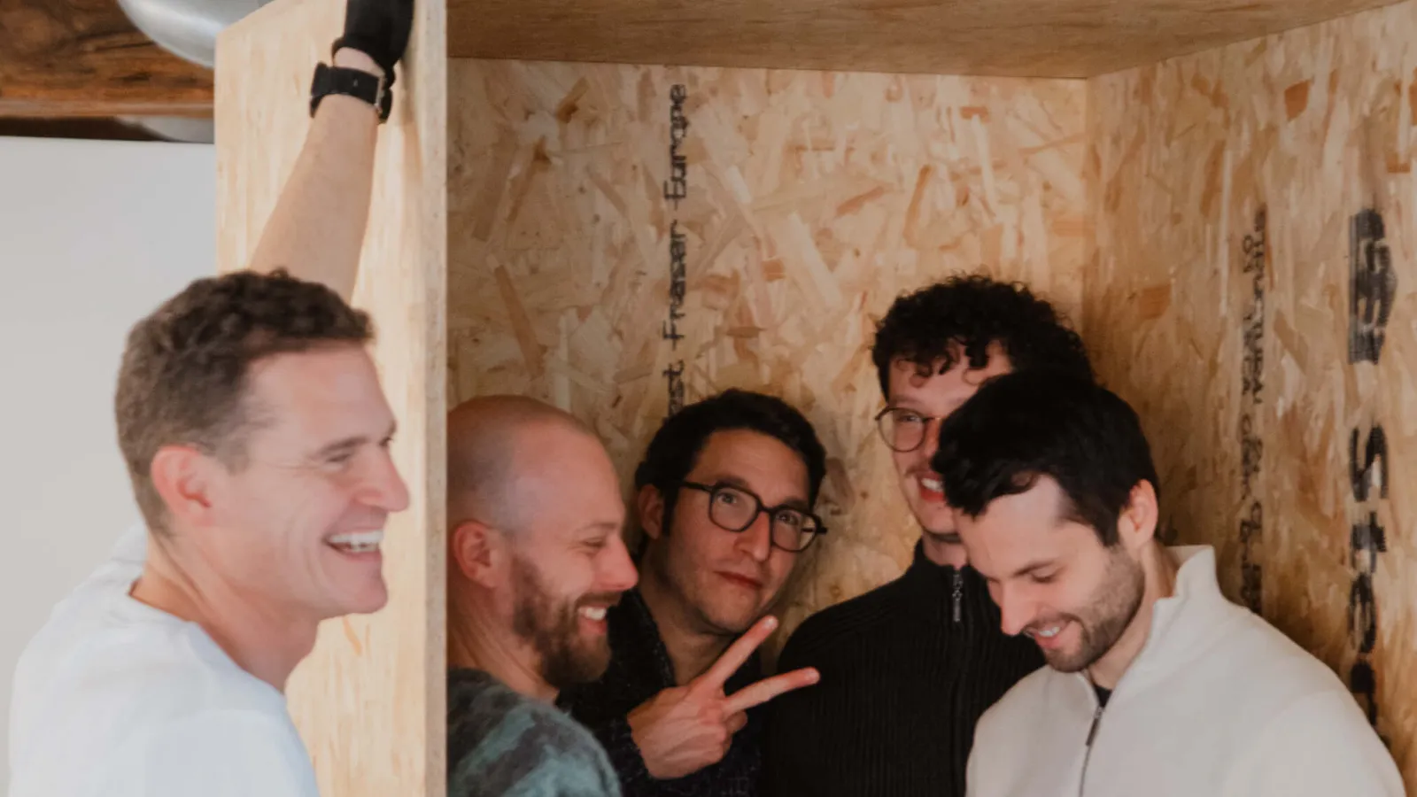 The Sevendays team together inside a wooden box