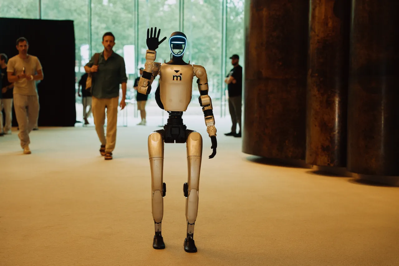 A humanoid robot waving to attendees at Off the Radar in Brussels